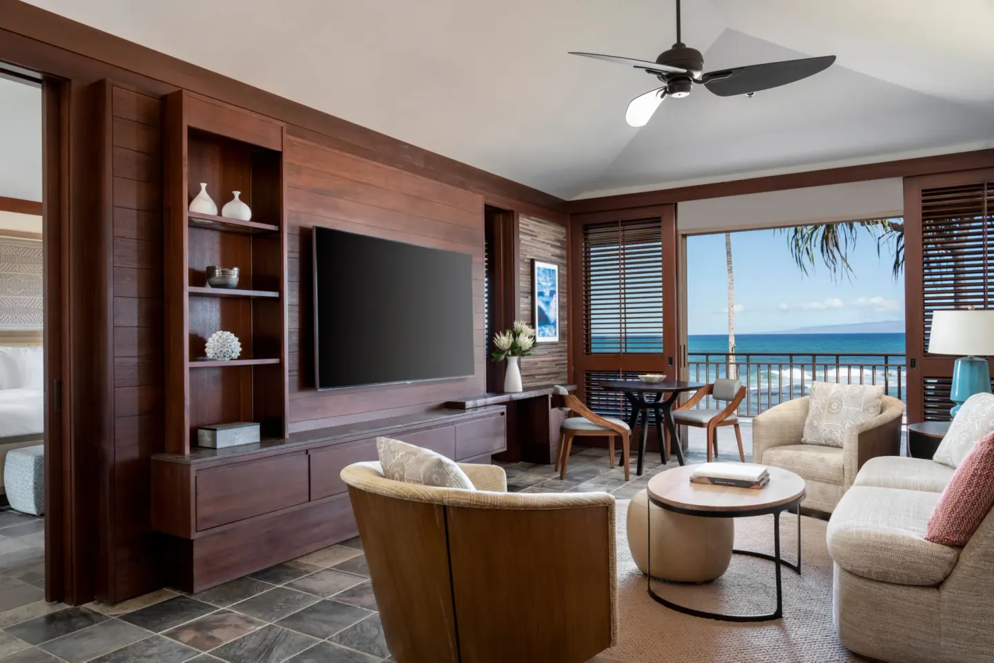 Oceanfront one-bedroom Superior Suite living room at Four Seasons Resort Hualalai with balcony and sea view.