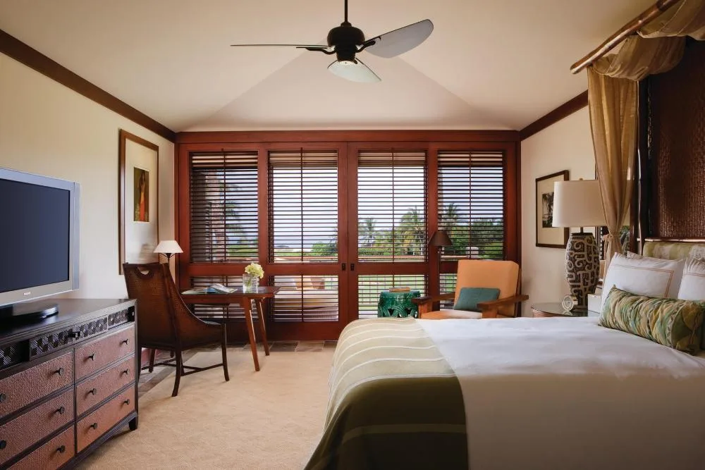 Superior Suite Ocean Golf View room with shutters and desk at Four Seasons Resort Hualalai.