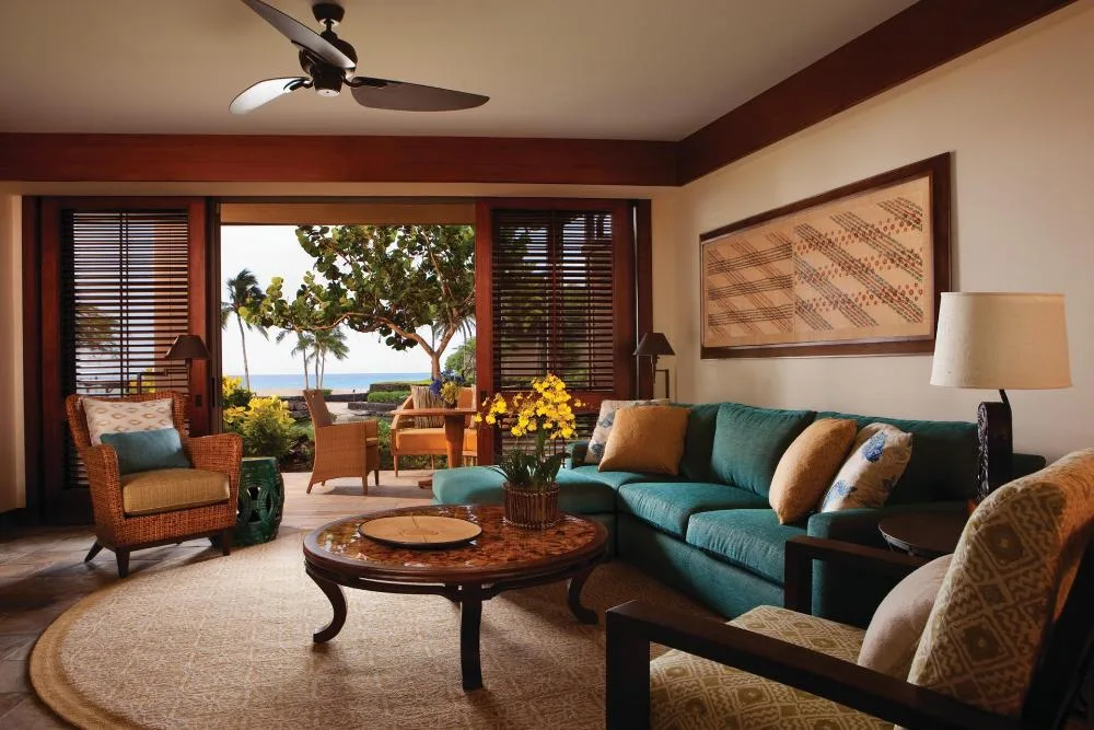 Superior Suite living room with ocean-facing lanai at Four Seasons Resort Hualalai.