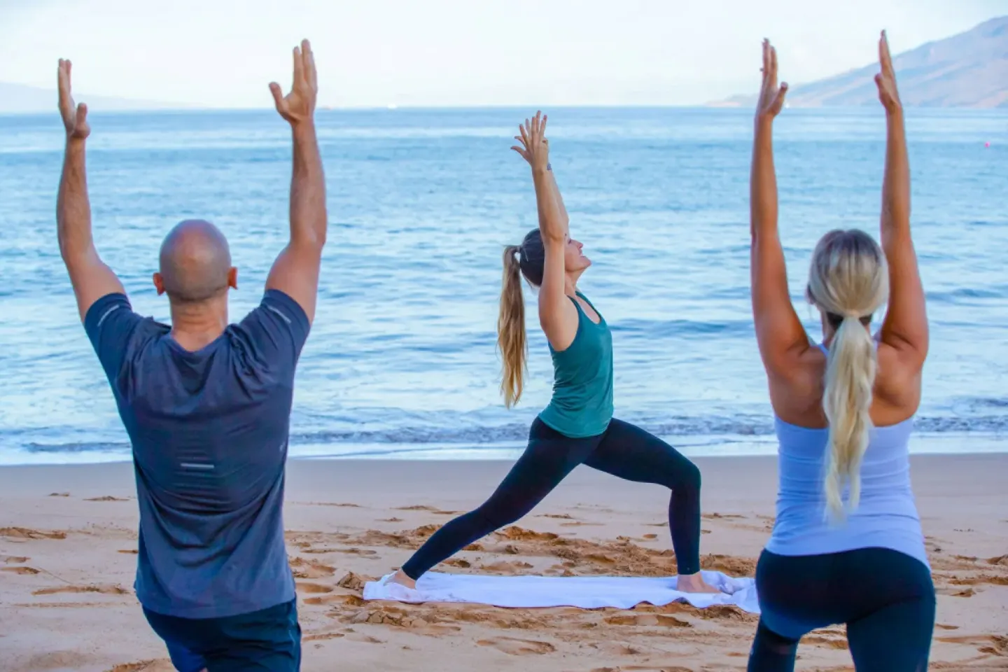 Beach yoga class beside the ocean at Four Seasons Resort Maui at Wailea.