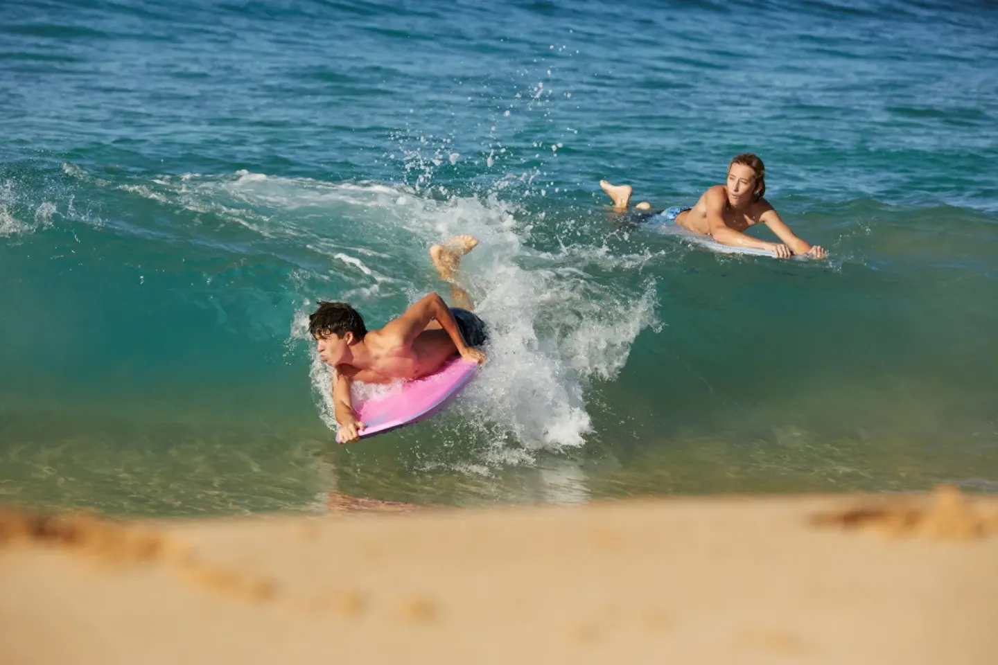 Boogie boarders ride a shore break near Four Seasons Resort Maui at Wailea.