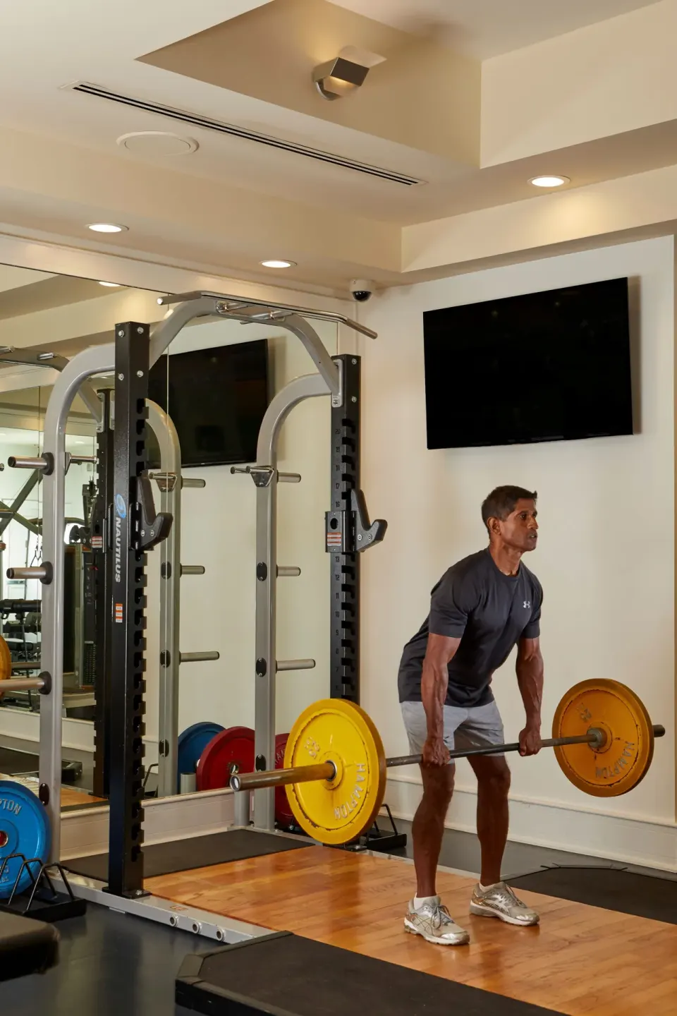 Guest lifts weights in the fitness center at Four Seasons Resort Maui at Wailea.