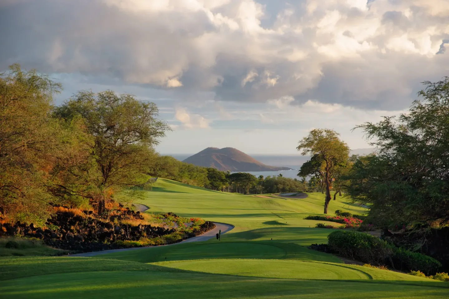 A green golf fairway overlooks the ocean near Four Seasons Resort Maui at Wailea.