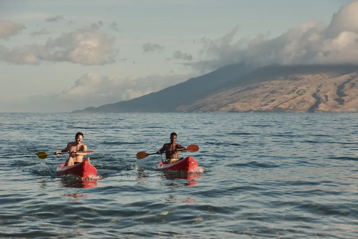 Two kayakers paddle on the ocean near Four Seasons Resort Maui at Wailea.