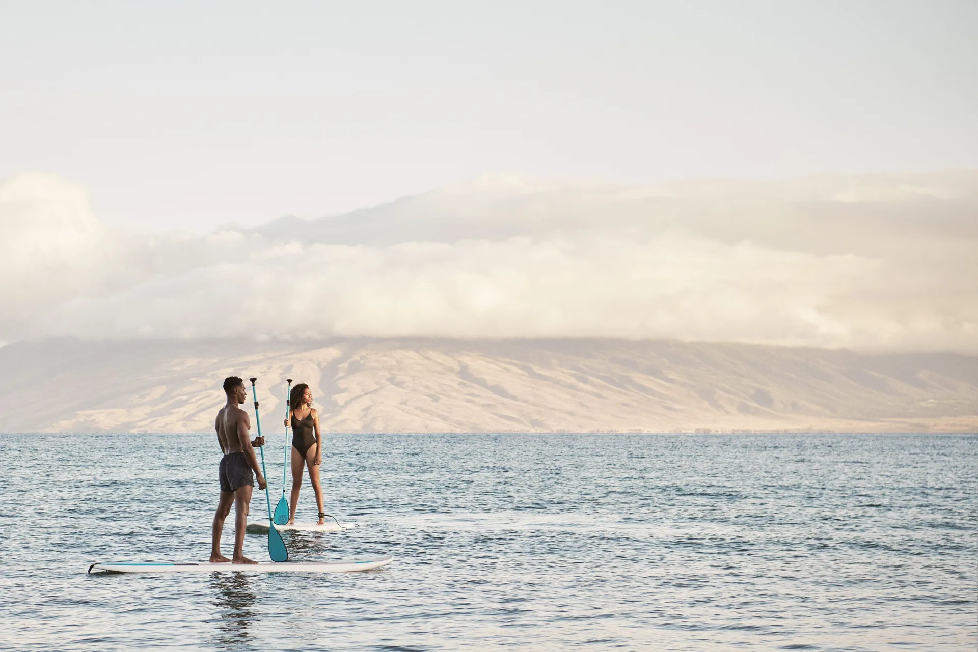Guests paddleboarding on the ocean at Four Seasons Resort Maui at Wailea.