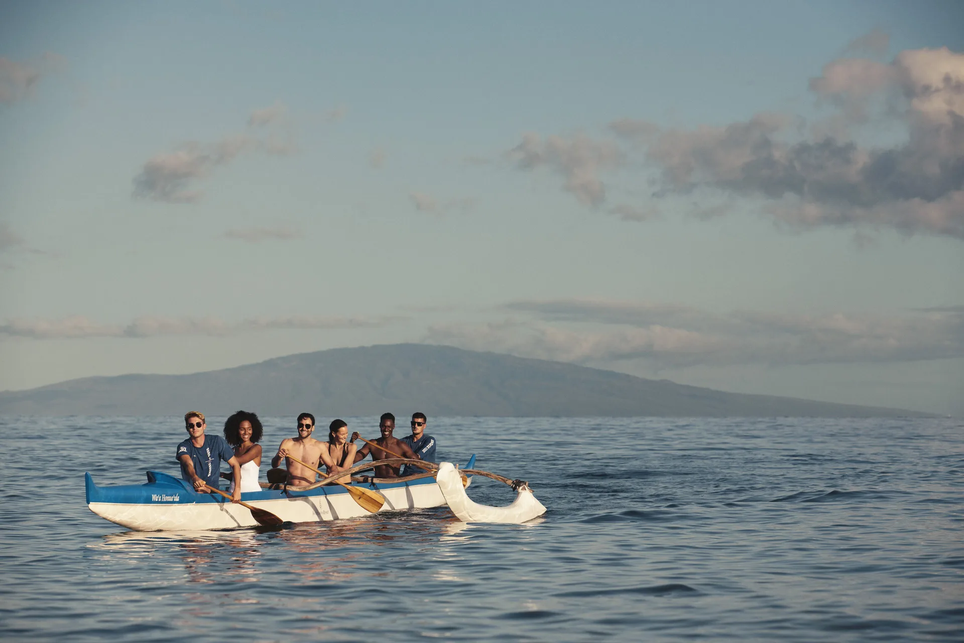 Guests paddling an outrigger canoe at Four Seasons Resort Maui at Wailea.