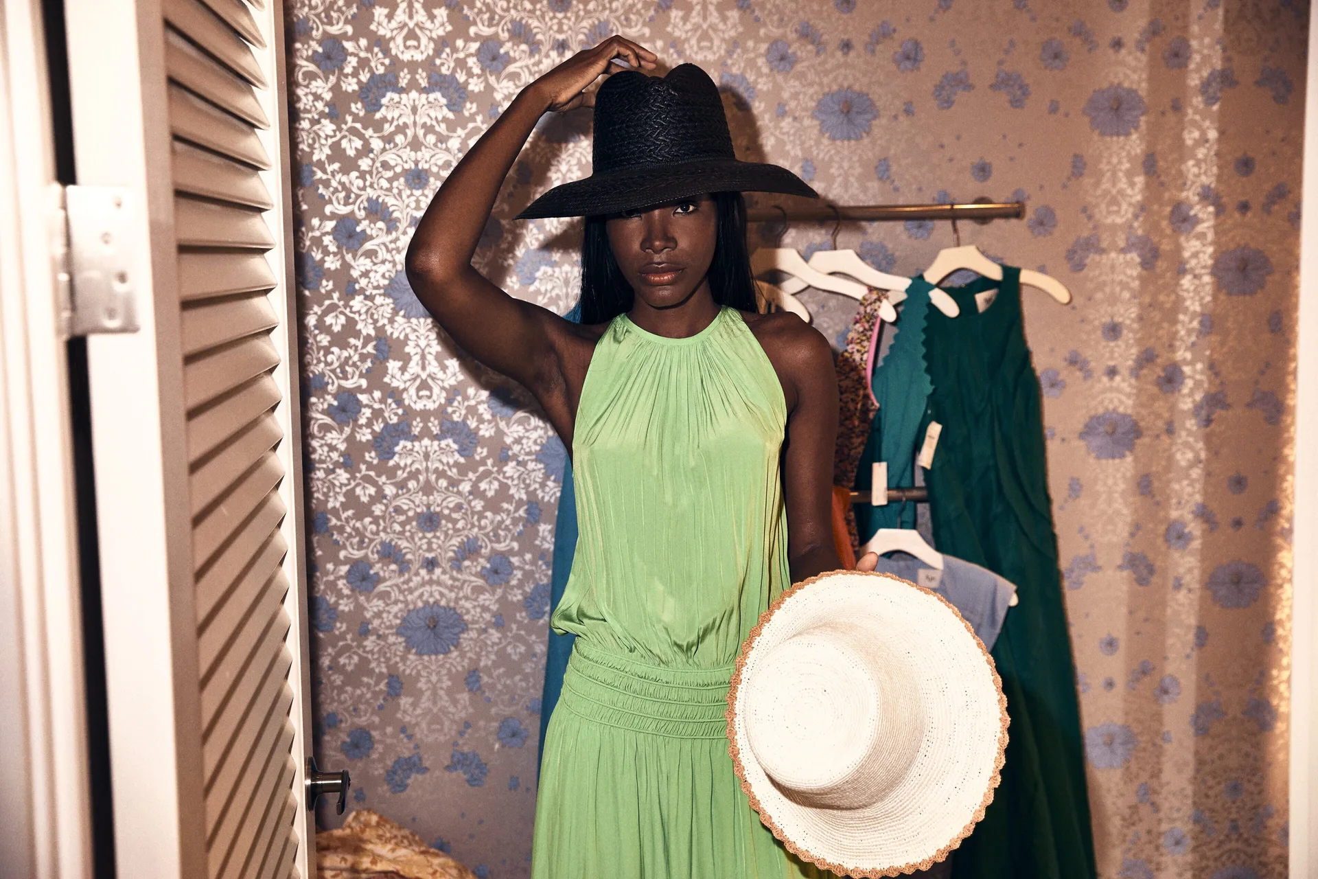 Guest trying on hats in a boutique at Four Seasons Resort Maui at Wailea.