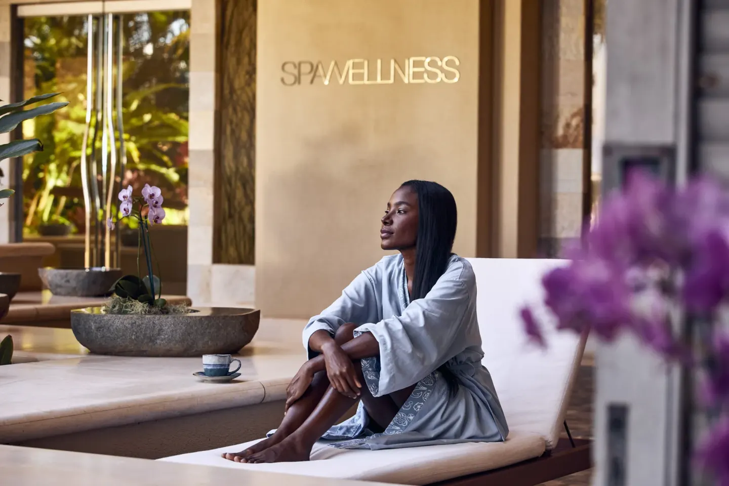 Guest relaxing in robe at spa wellness entrance at Four Seasons Resort Maui at Wailea.