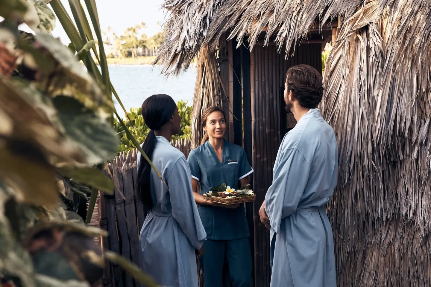 Guests in robes speaking with a spa attendant at Four Seasons Resort Maui at Wailea.