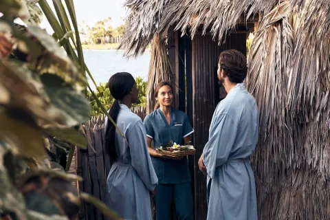 Guests in robes speaking with a spa attendant at Four Seasons Resort Maui at Wailea.