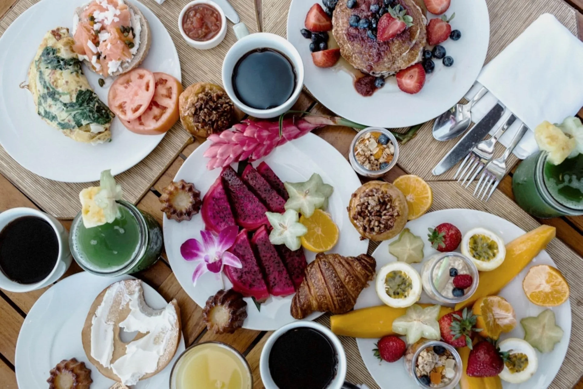 Overhead breakfast spread with fruit, pastries, coffee, and juices at Four Seasons Resort Maui at Wailea.