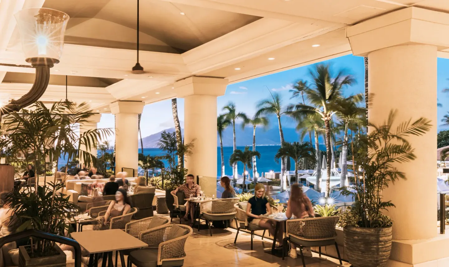Open-air lounge seating overlooks the pool and ocean at Four Seasons Resort Maui at Wailea.