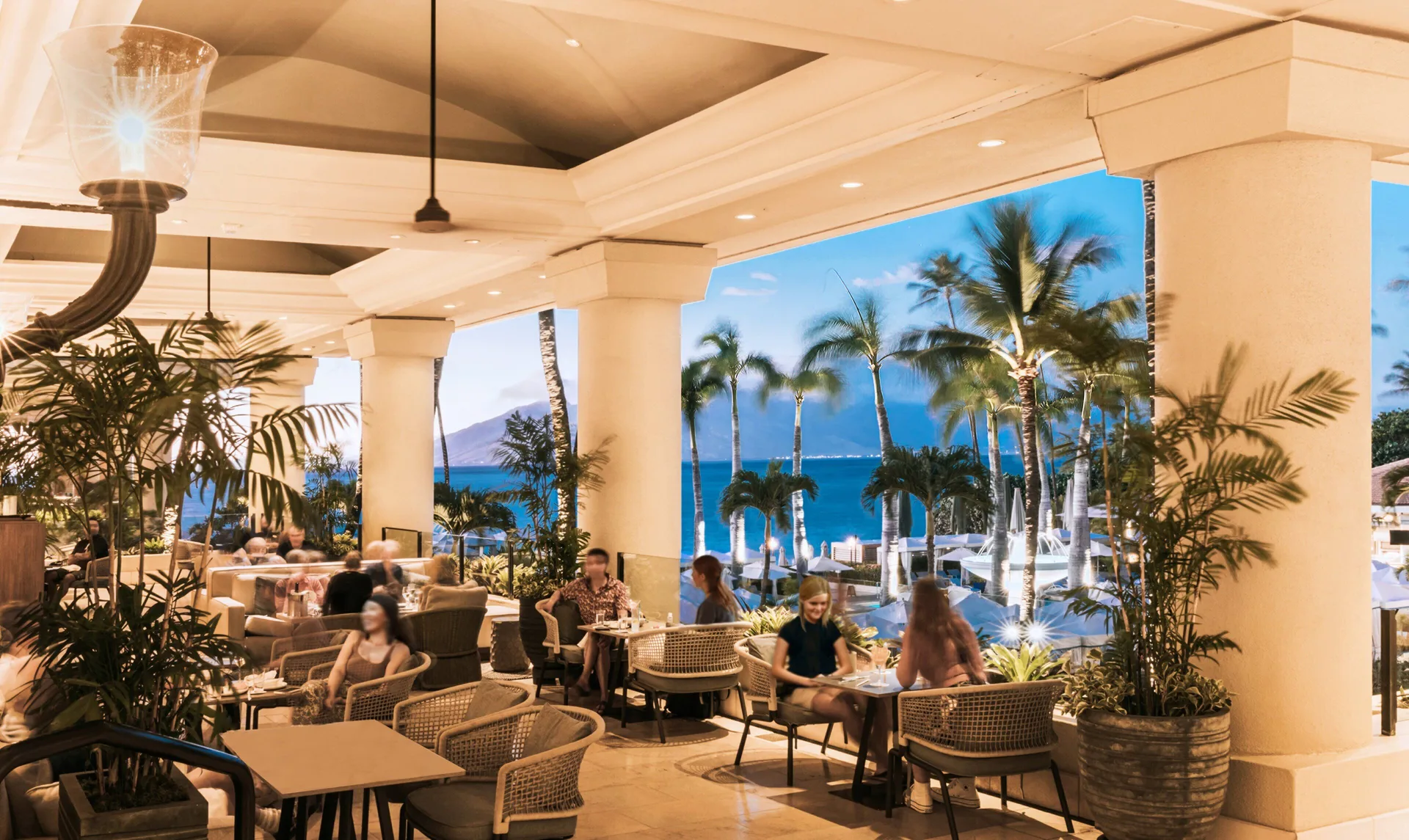 Open-air lounge seating overlooks the pool and ocean at Four Seasons Resort Maui at Wailea.