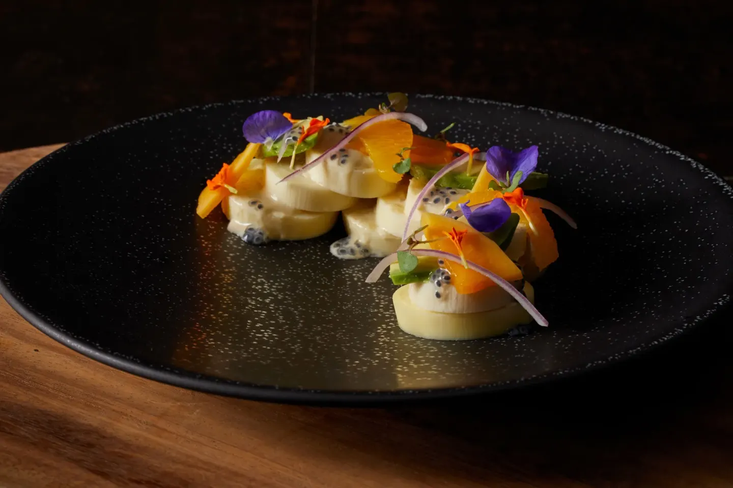 A plated dish with edible flowers is served at Four Seasons Resort Maui at Wailea.