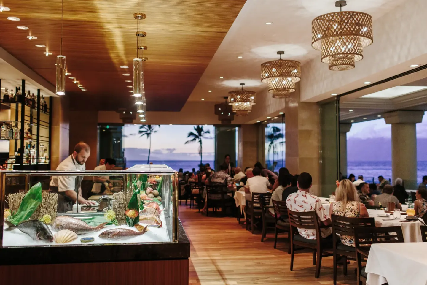 A seafood display and dining room face the ocean at Four Seasons Resort Maui at Wailea.