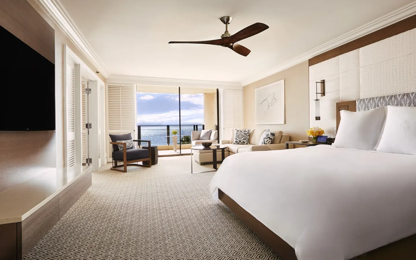 Club Ocean Front One Bedroom Suite king bed and ocean-view lanai at Four Seasons Resort Maui at Wailea.
