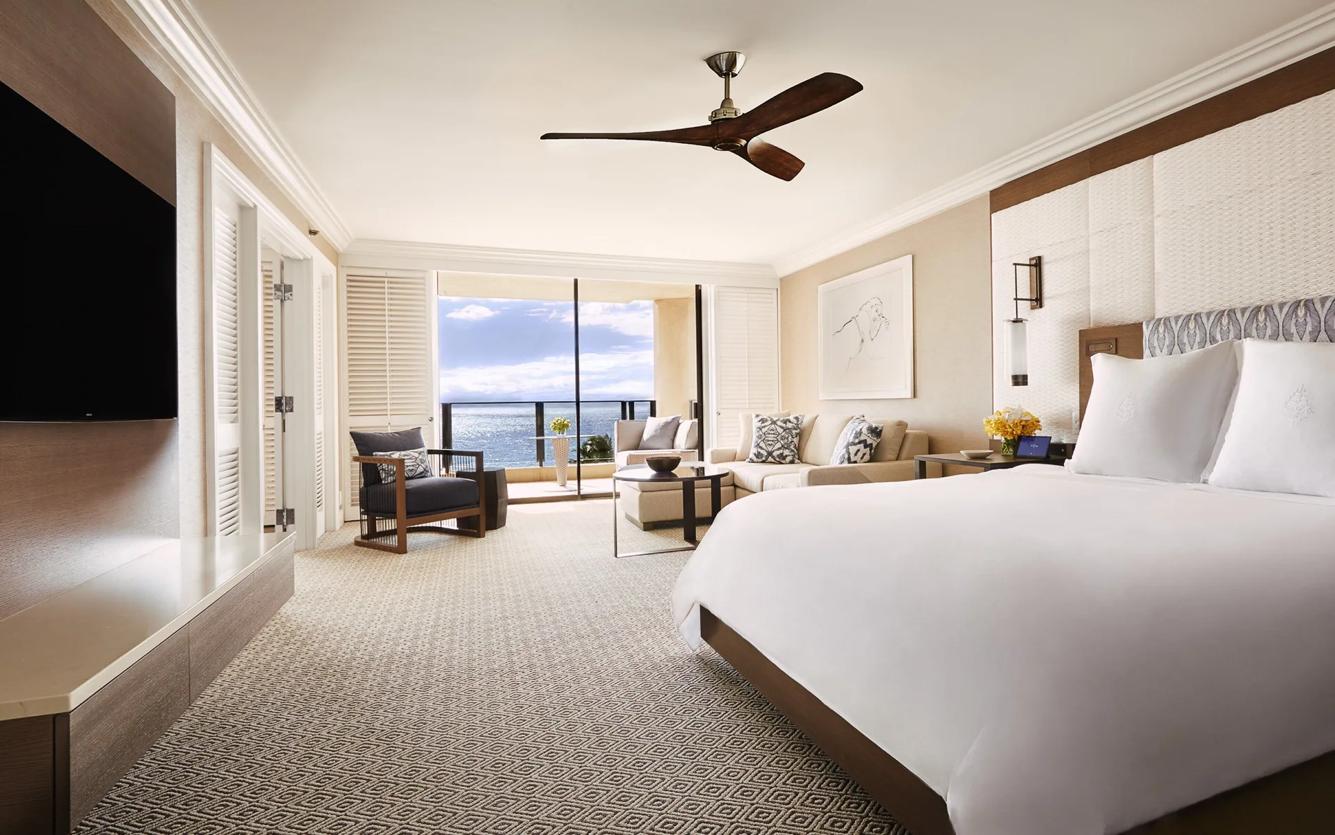 Club Ocean Front One Bedroom Suite king bed and ocean-view lanai at Four Seasons Resort Maui at Wailea.
