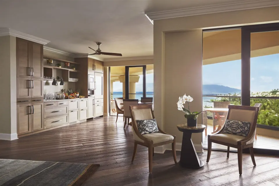 Club Ocean View Room seating area and balcony doors at Four Seasons Resort Maui at Wailea.