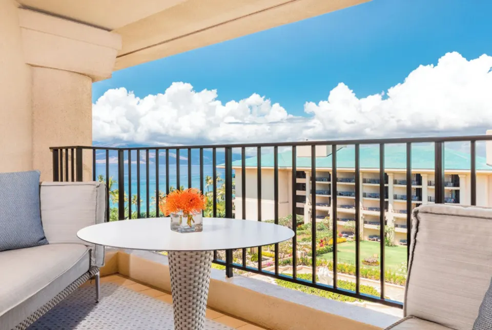 Deluxe Club Ocean View Room balcony seating and ocean view at Four Seasons Resort Maui at Wailea.