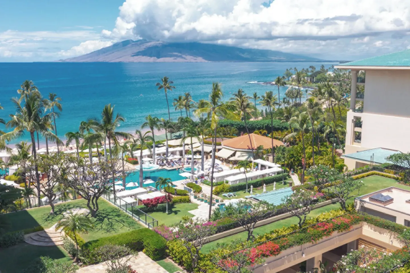 Deluxe Club Ocean View Room vista over pools, palms and ocean at Four Seasons Resort Maui at Wailea.