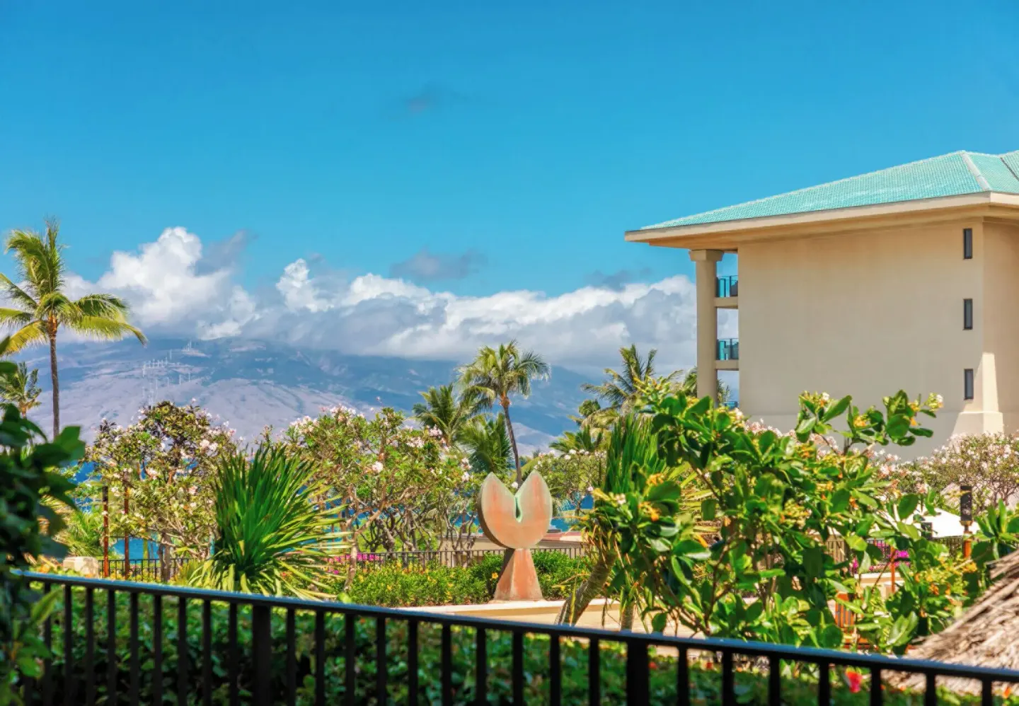 Deluxe Garden View Room balcony view with palms and resort gardens at Four Seasons Resort Maui at Wailea.