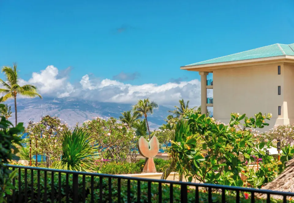 Deluxe Garden View Room balcony view with palms and resort gardens at Four Seasons Resort Maui at Wailea.