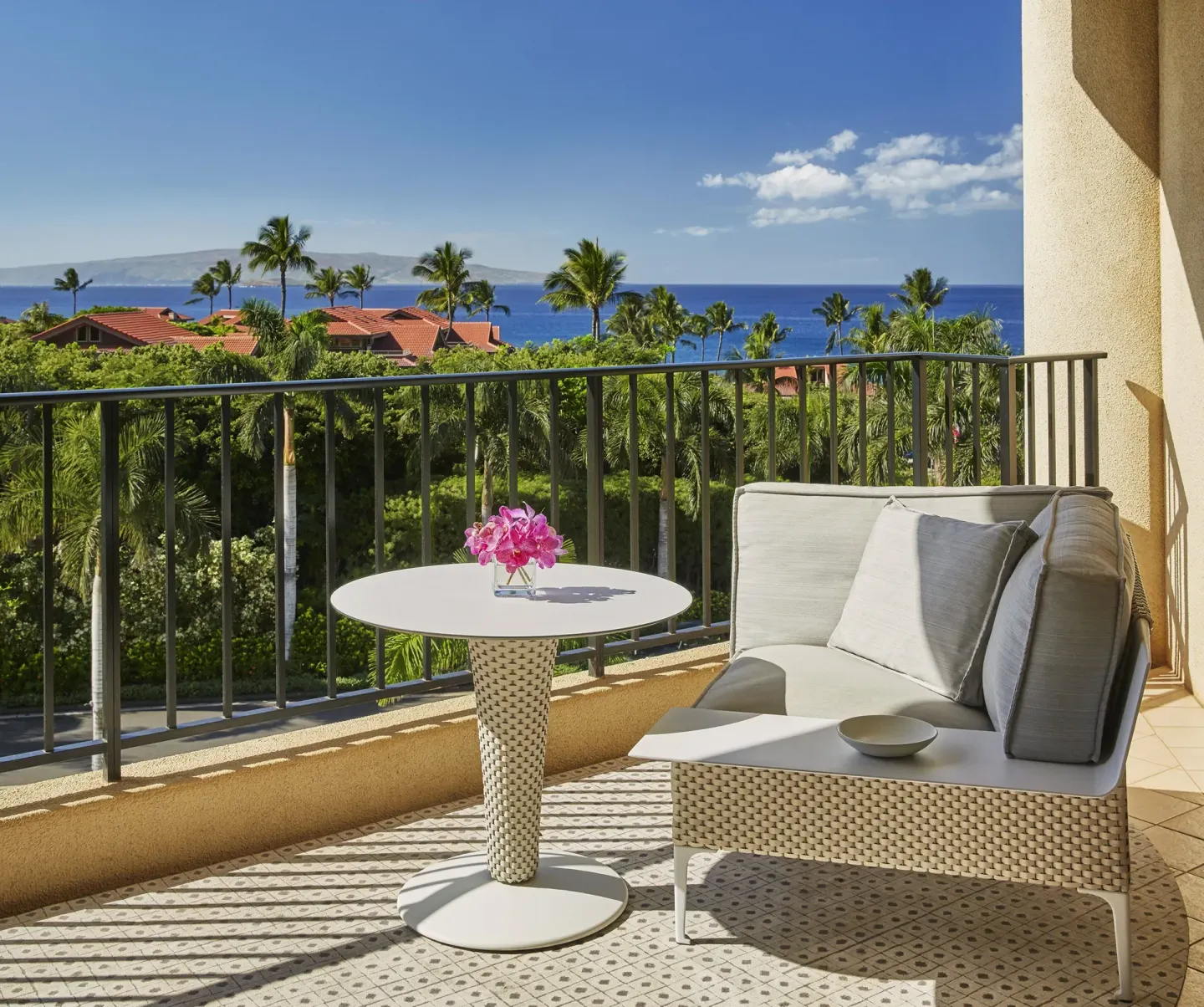 Deluxe Ocean View Room lanai with seating and ocean at Four Seasons Resort Maui at Wailea.