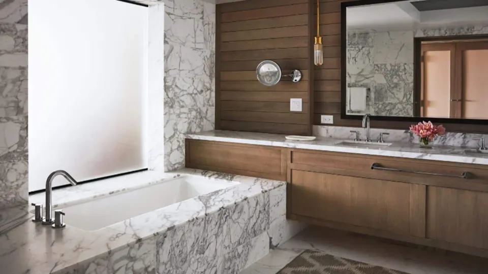 Elite Ocean Front Two Bedroom Suite bathroom at Four Seasons Resort Maui at Wailea with marble tub and vanity.