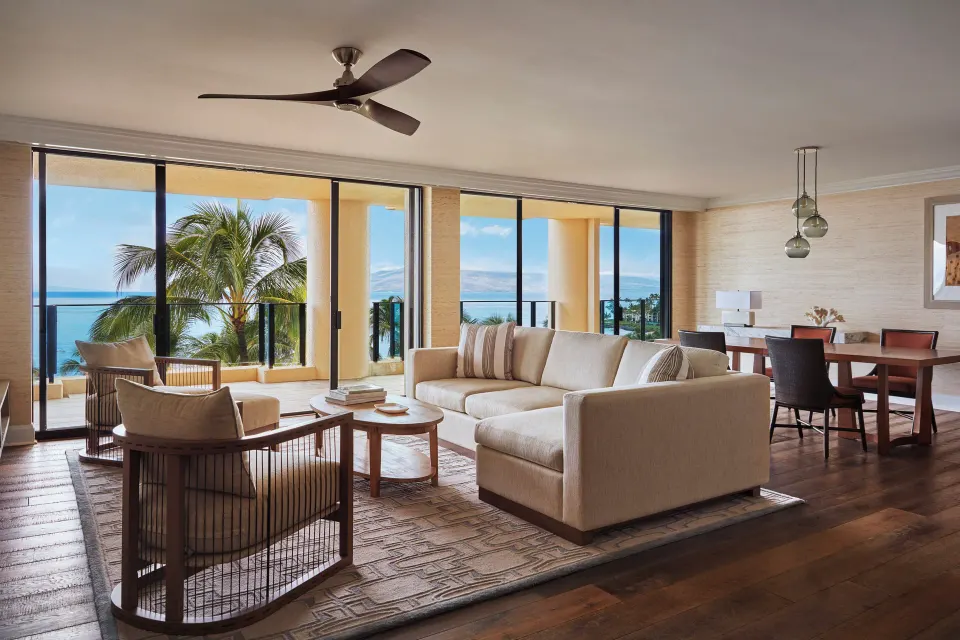 Elite Ocean Front Two Bedroom Suite living room at Four Seasons Resort Maui at Wailea with ocean-facing glass doors.