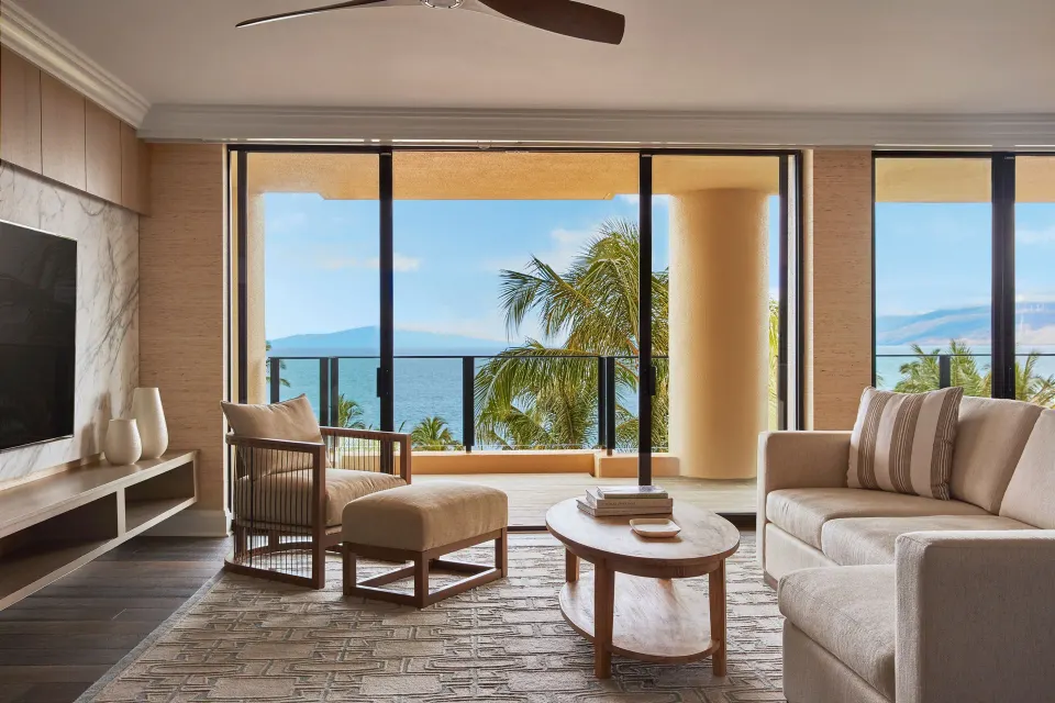 Elite Ocean Front Two Bedroom Suite lounge at Four Seasons Resort Maui at Wailea with sofa, TV and ocean view.
