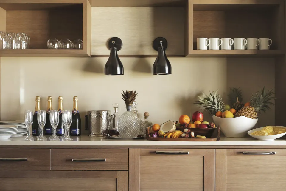 Elite Ocean Front Two Bedroom Suite refreshment counter at Four Seasons Resort Maui at Wailea with fruit and glassware.