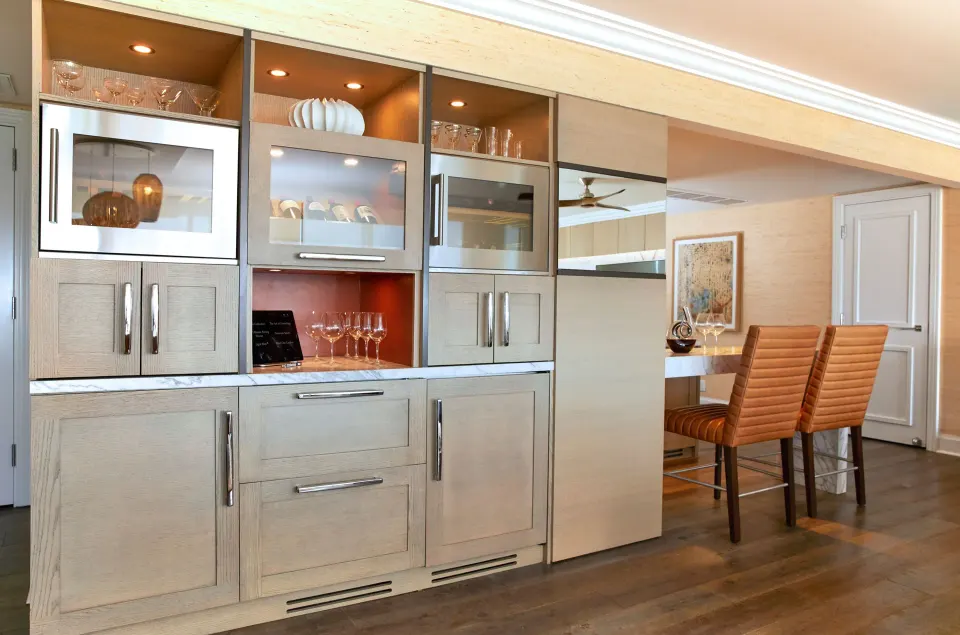 Elite Ocean Front Two Bedroom Suite wet bar at Four Seasons Resort Maui at Wailea with glassware and bar stools.