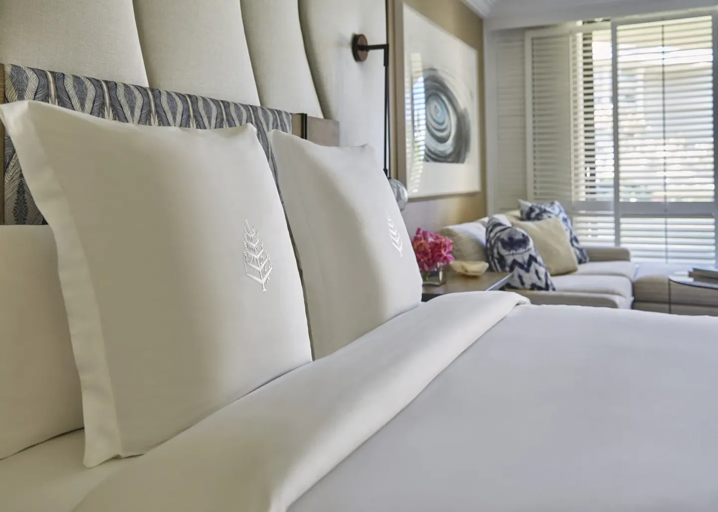 Garden View Accessible Room king bed at Four Seasons Resort Maui at Wailea with sofa and shuttered windows.