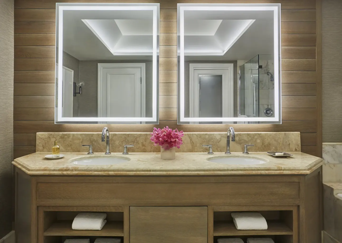 Garden View Room bathroom vanity at Four Seasons Resort Maui at Wailea with dual sinks and lit mirrors.
