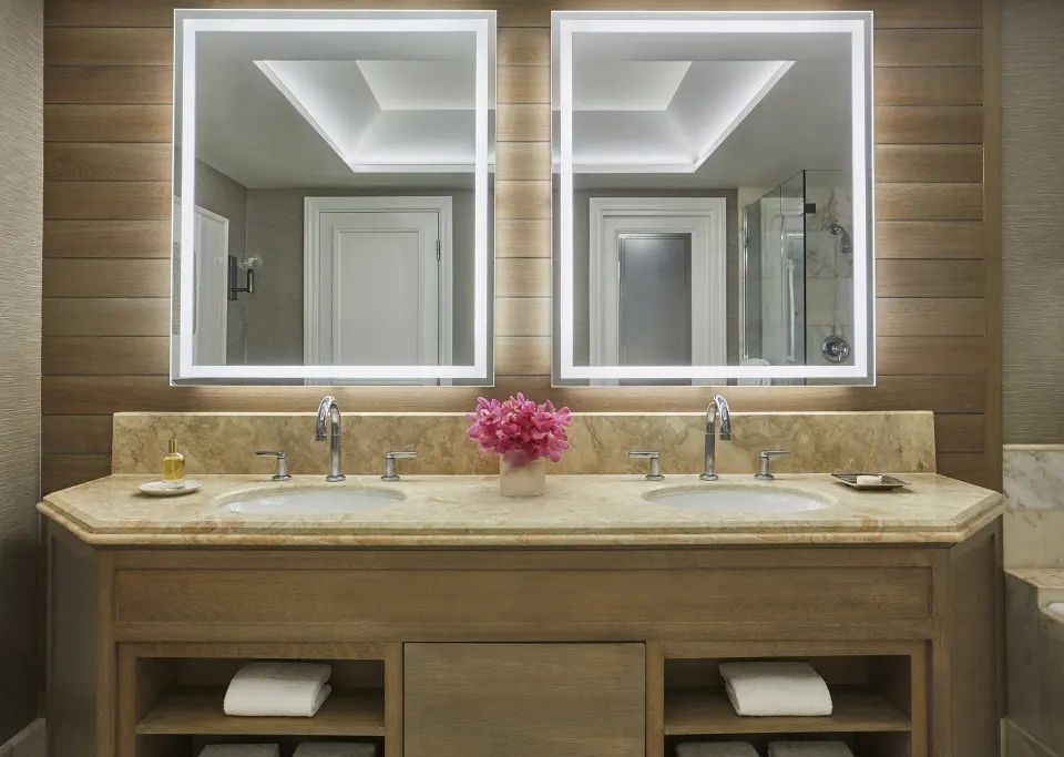 Garden View Room bathroom vanity at Four Seasons Resort Maui at Wailea with dual sinks and lit mirrors.