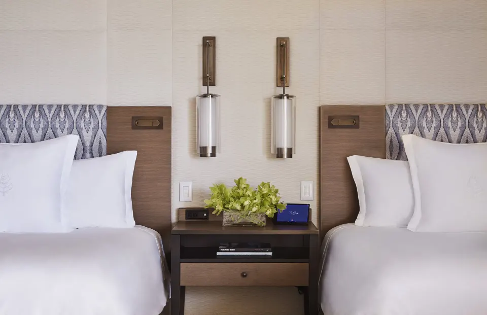 Garden View Room with two beds at Four Seasons Resort Maui at Wailea, shown with a central nightstand.