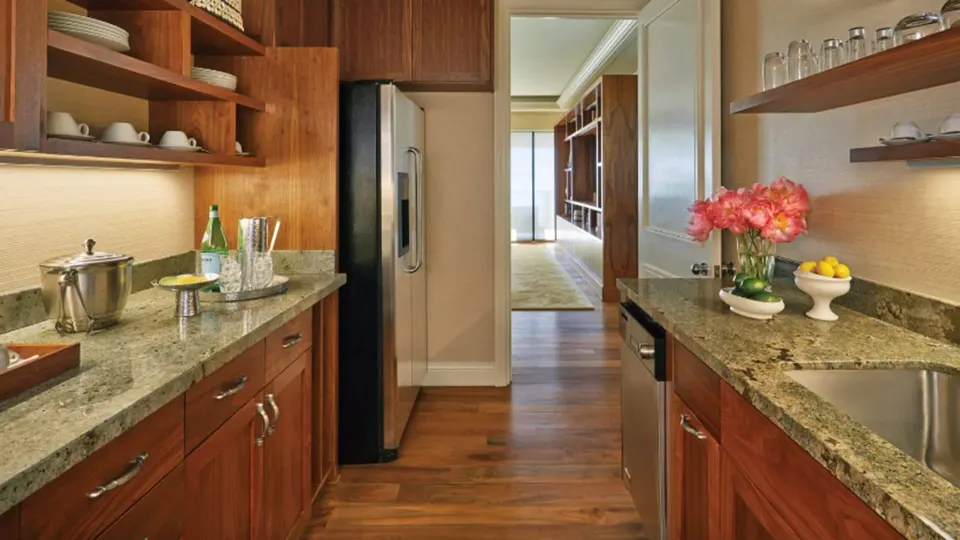 Maile Presidential Suite kitchen with wood cabinetry at Four Seasons Resort Maui at Wailea.