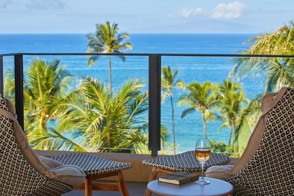 Maile Presidential Suite lanai chairs overlooking ocean at Four Seasons Resort Maui at Wailea.