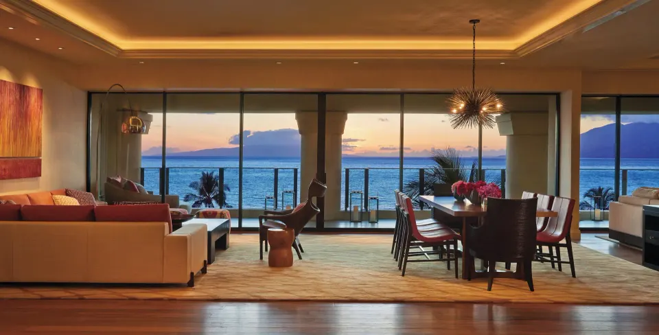 Maile Presidential Suite living and dining room at sunset at Four Seasons Resort Maui at Wailea.