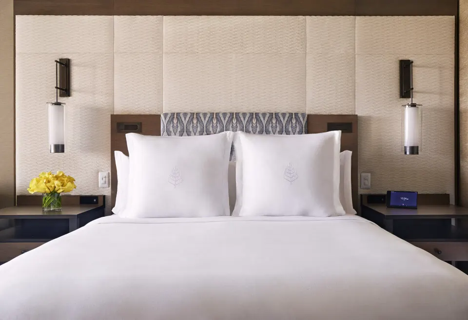 Mountainside Room king bed with white linens at Four Seasons Resort Maui at Wailea.