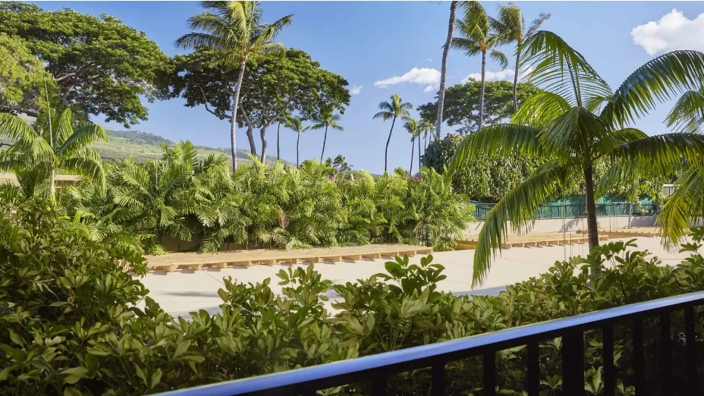 Mountainside Room lanai view with palms and hills at Four Seasons Resort Maui at Wailea.