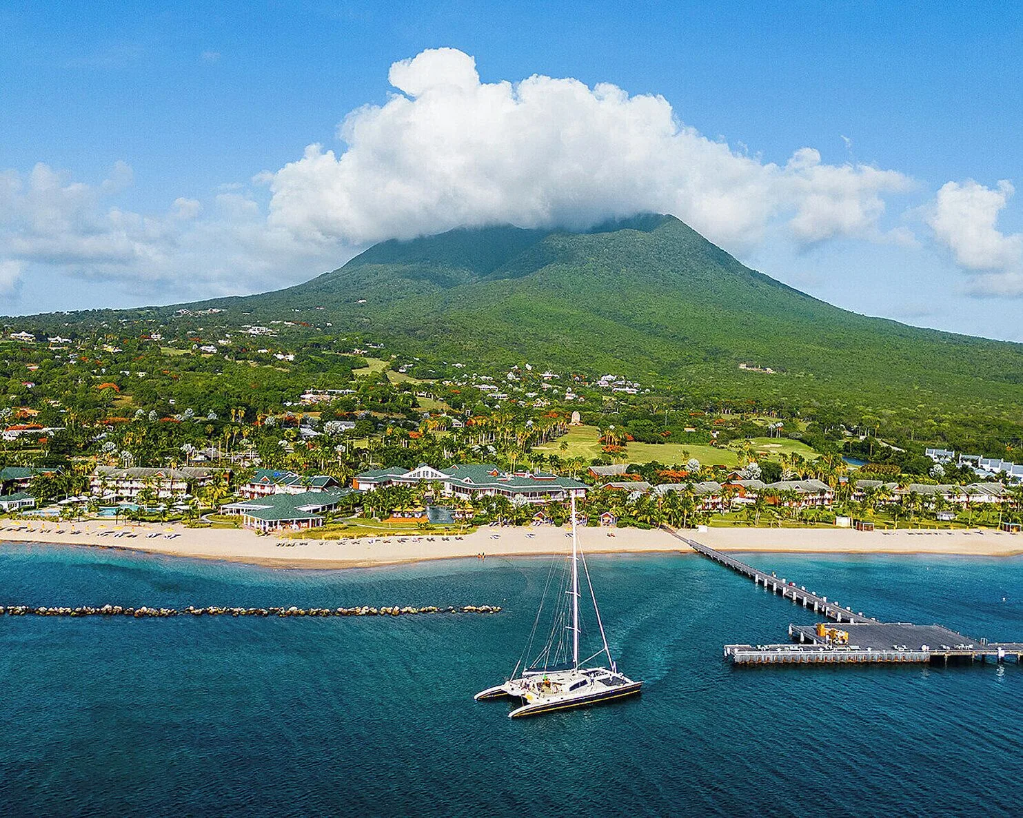 Aerial view of the beachfront and Nevis Peak at Four Seasons Resort Nevis.