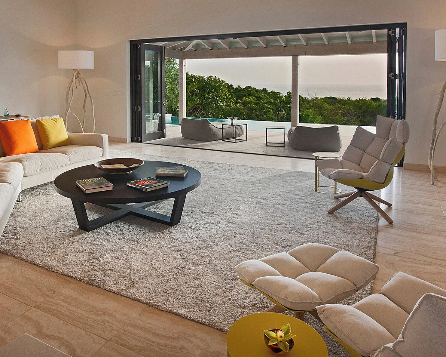 Contemporary living room with terrace and pool edge at Four Seasons Resort Nevis.