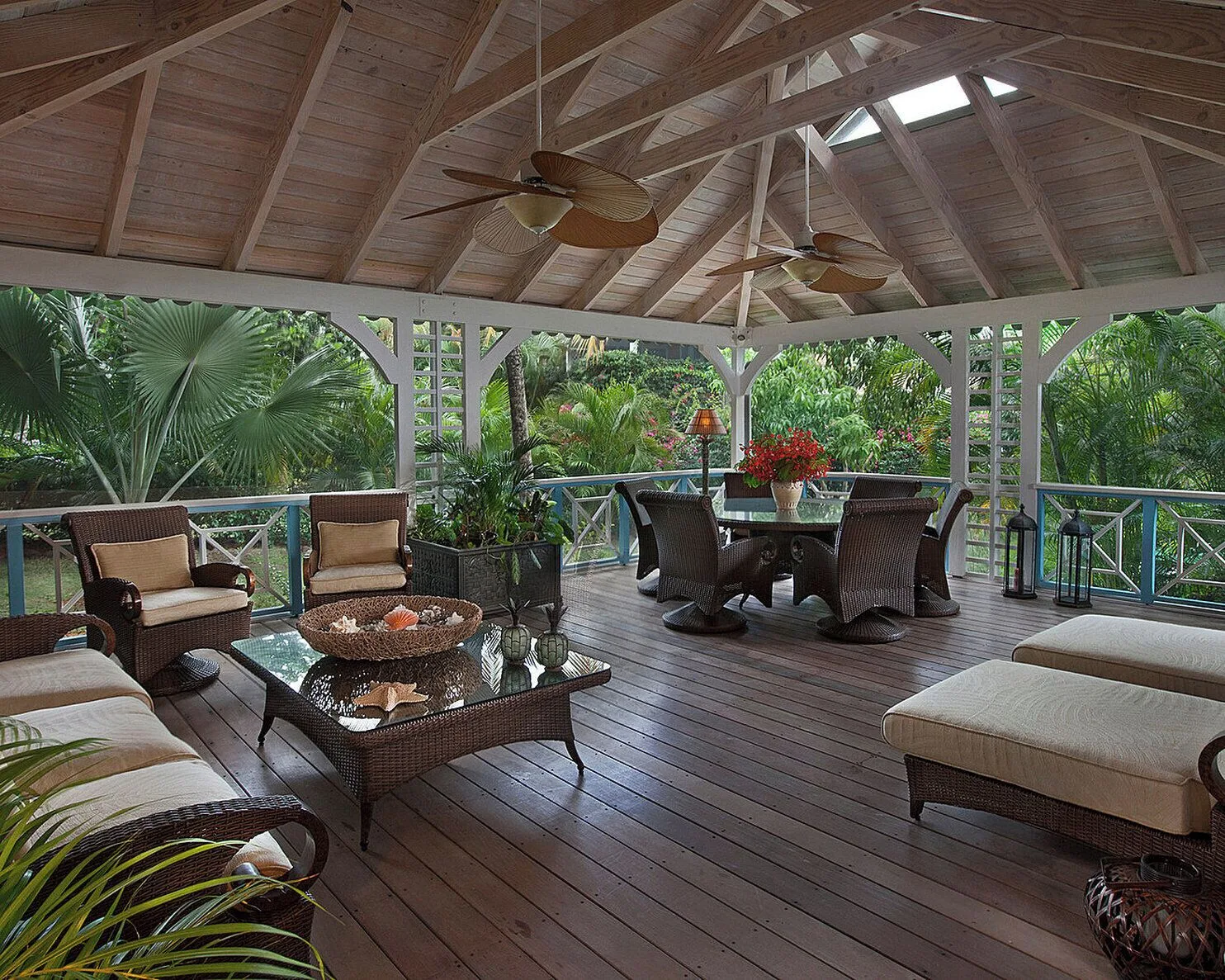 Covered veranda with wicker seating and garden views at Four Seasons Resort Nevis.
