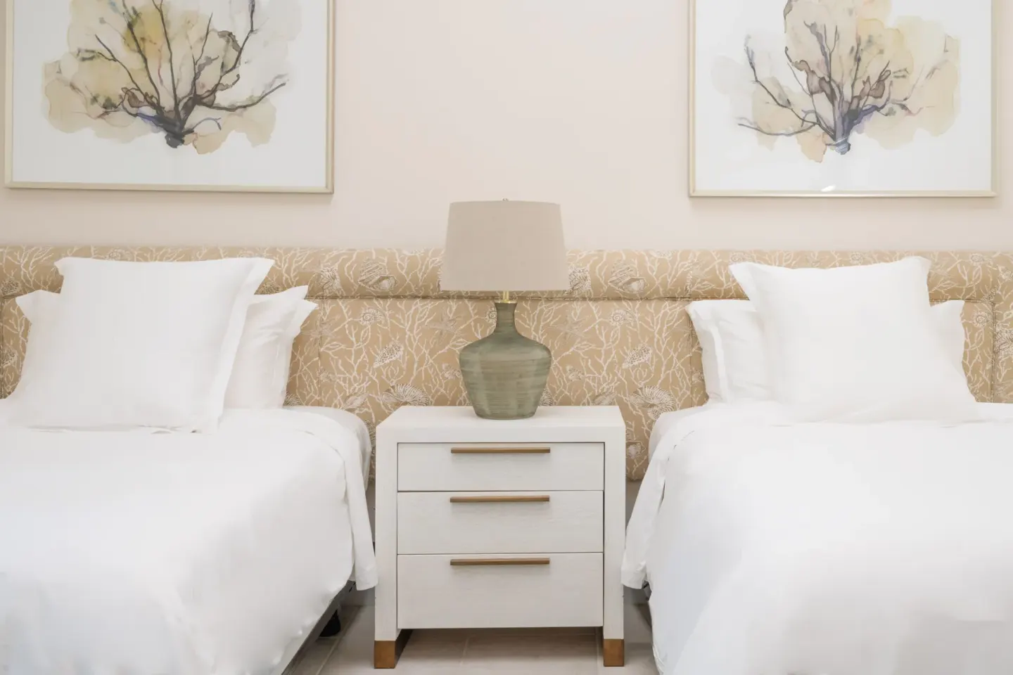 Two white twin beds with bedside table at Four Seasons Resort Nevis.