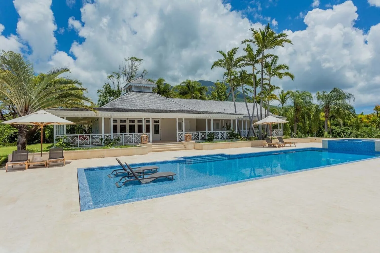 Large villa pool and veranda under palms at Four Seasons Resort Nevis.
