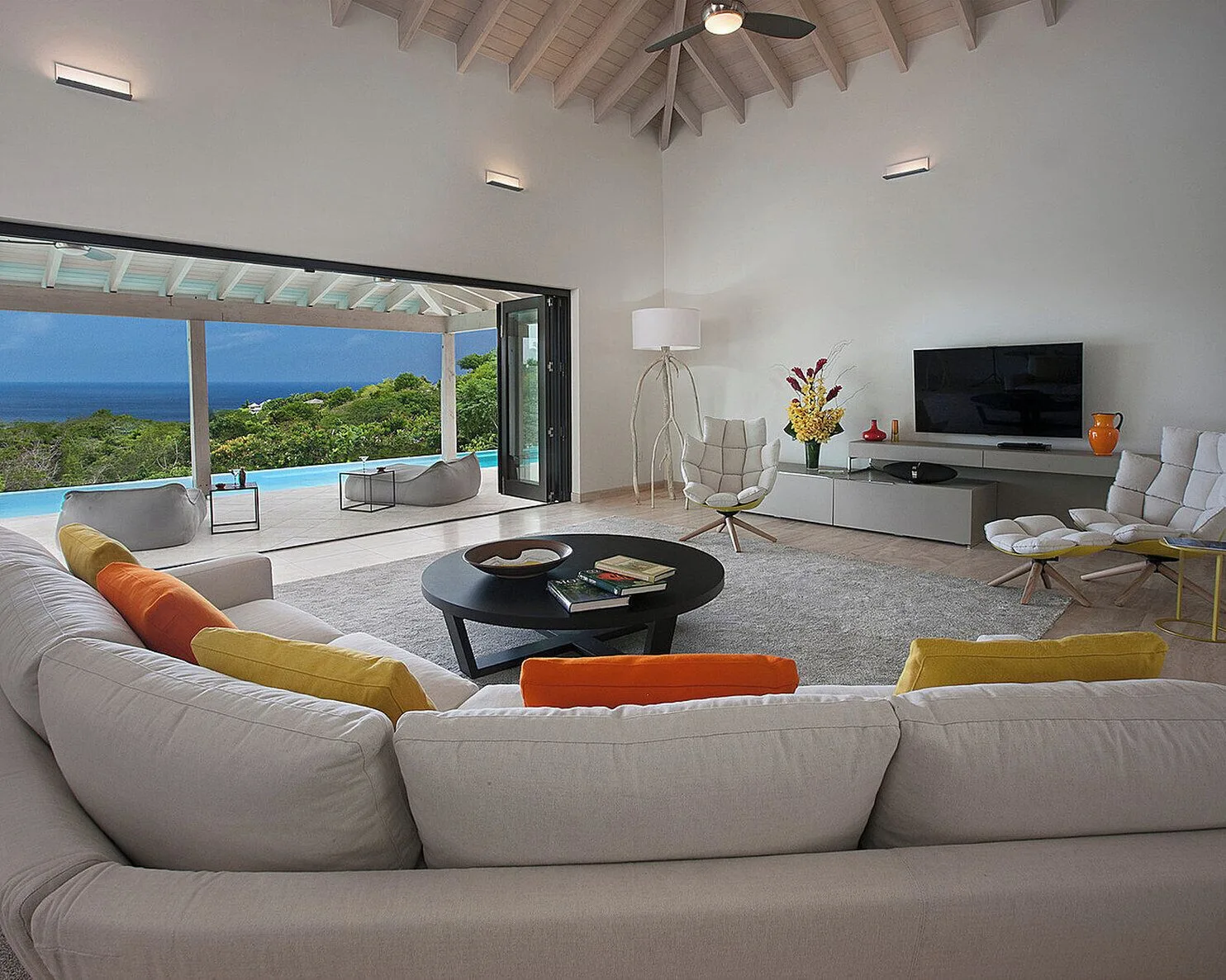 Ocean-view villa living room with terrace at Four Seasons Resort Nevis.