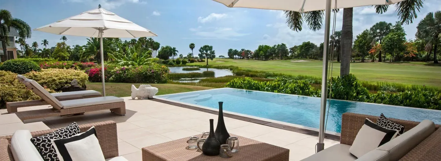 Terrace pool with shaded seating and golf course view at Four Seasons Resort Nevis.