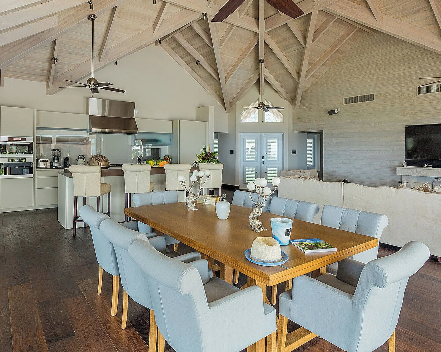 Open living and dining area with kitchen island at Four Seasons Resort Nevis.