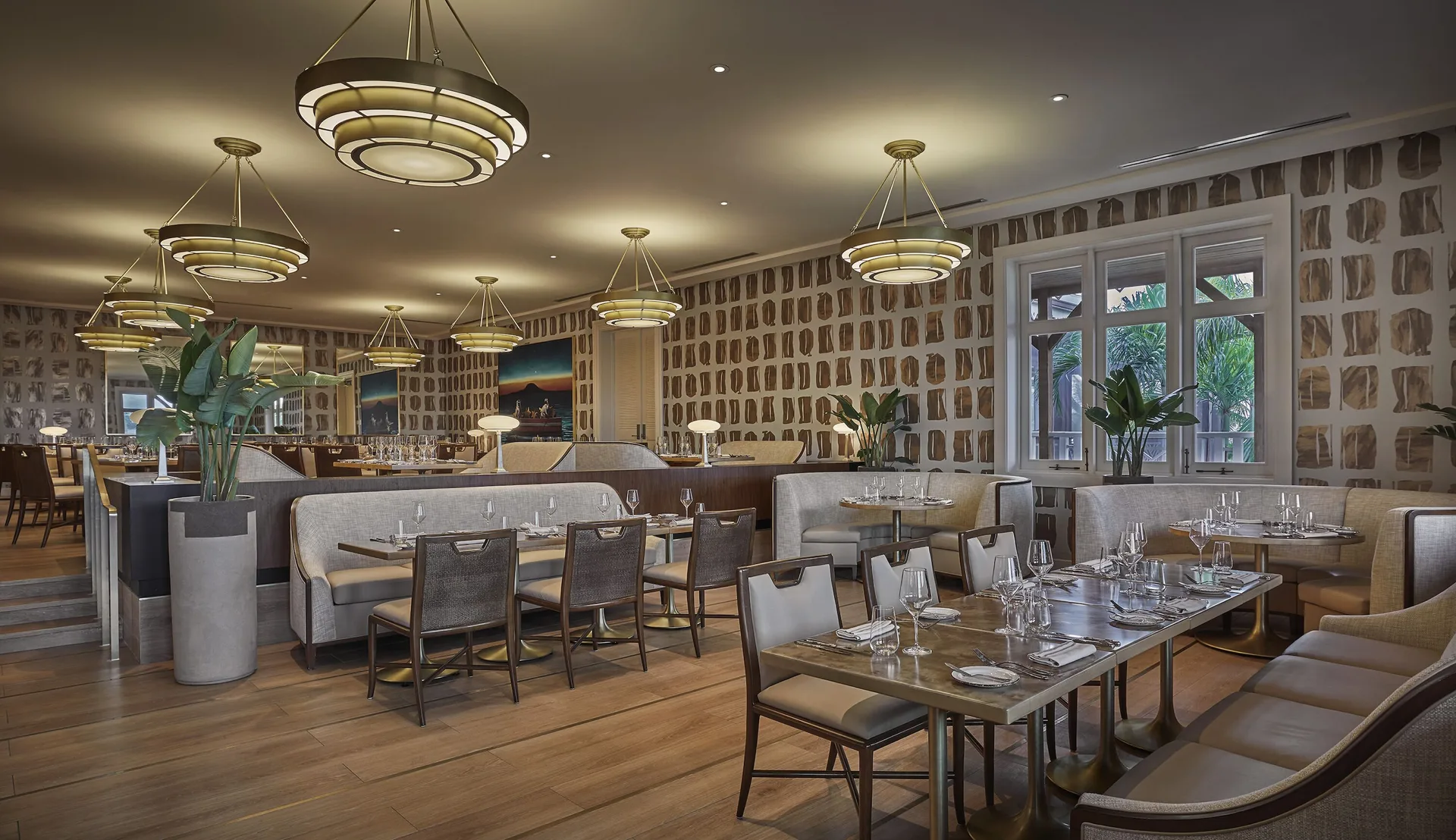 A spacious dining room with set tables at Four Seasons Resort Nevis.